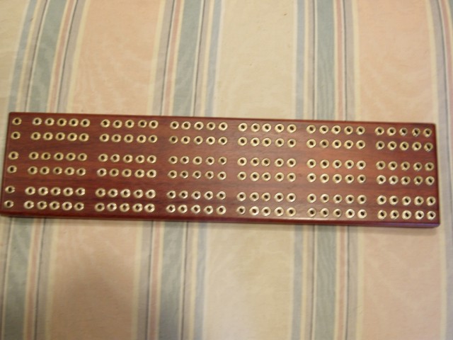 photo of the front side of a Cribbage board  